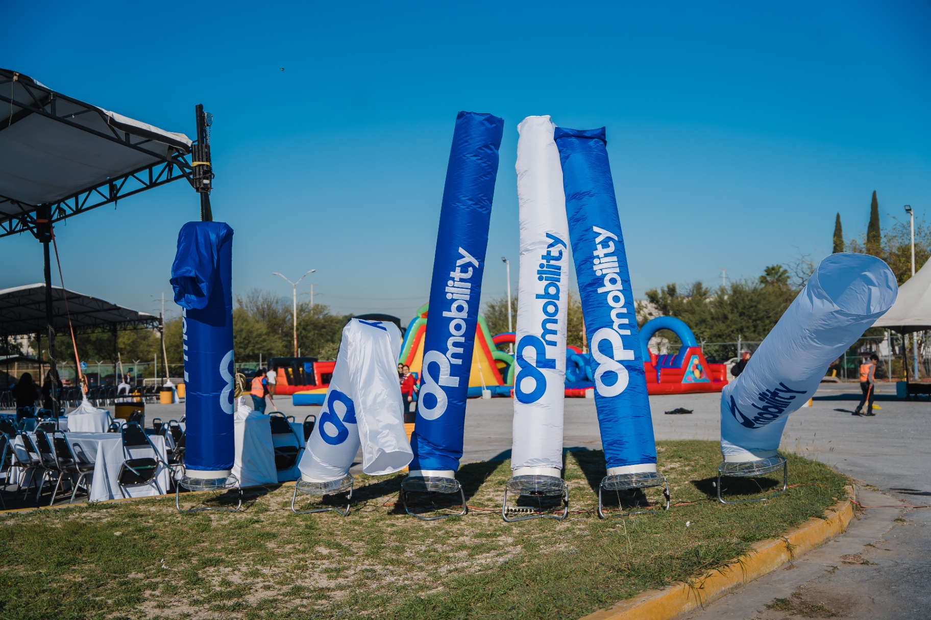 Inflables verticales con branding de OP Mobility en el área de acceso.
